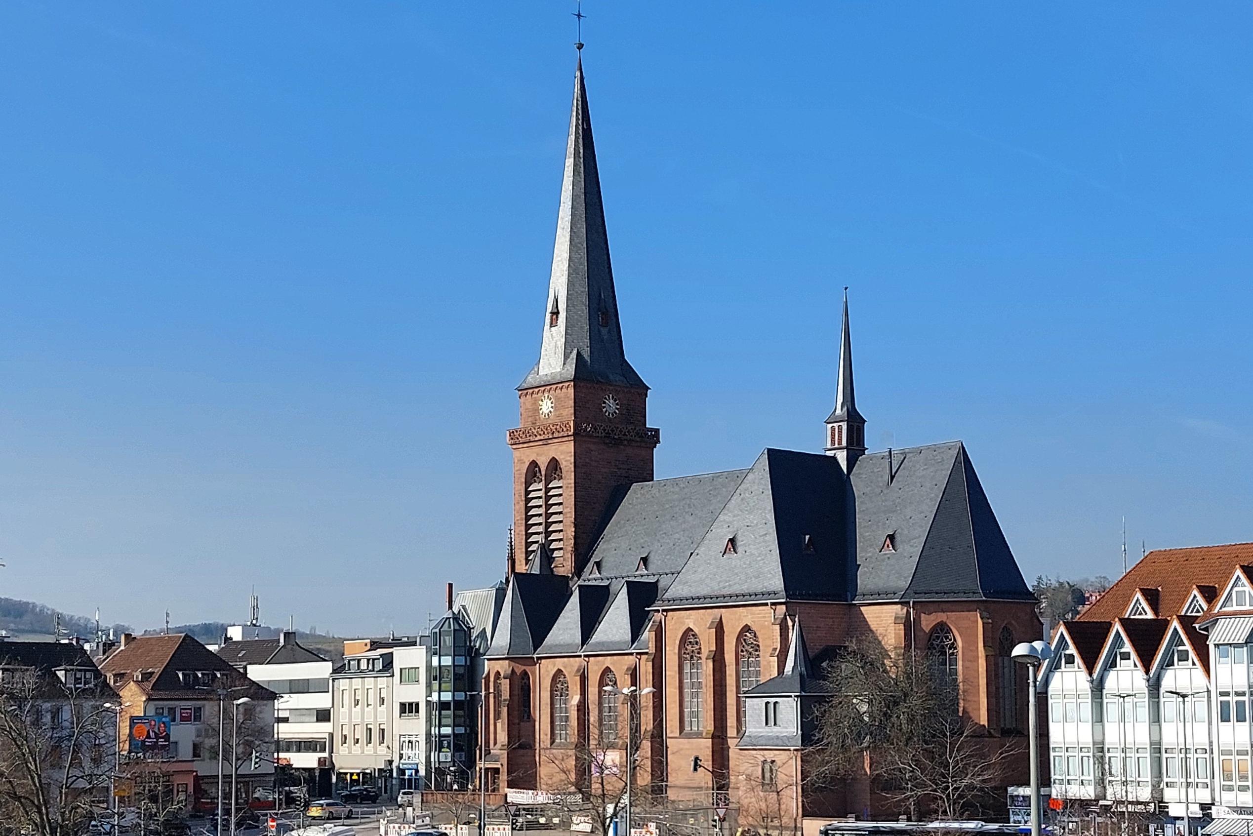 Das Bild zeigt die Hl.-Kreuz-Kirche mit den umgebenden Gebäuden aus der Richtung  des Fahrradparkhauses